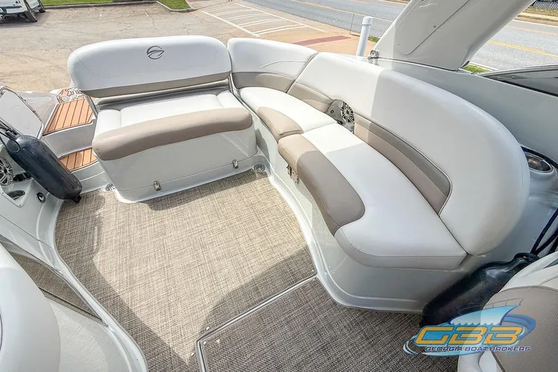 Slide: The Image of 2015 Crownline Eclipse E6 boat interior with cushioned seating and carpeted flooring. - 11