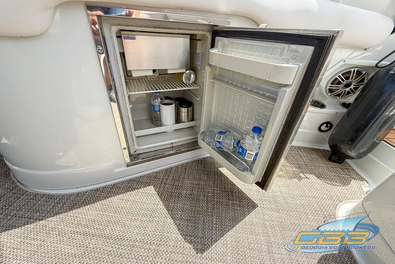 Slide: The Image of Open mini fridge on 2015 Crownline Eclipse E6 boat, containing drinks and water bottles. - 13