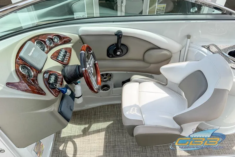 Slide: The Image of 2015 Crownline Eclipse E6 boat cockpit with steering wheel and control panel. - 18