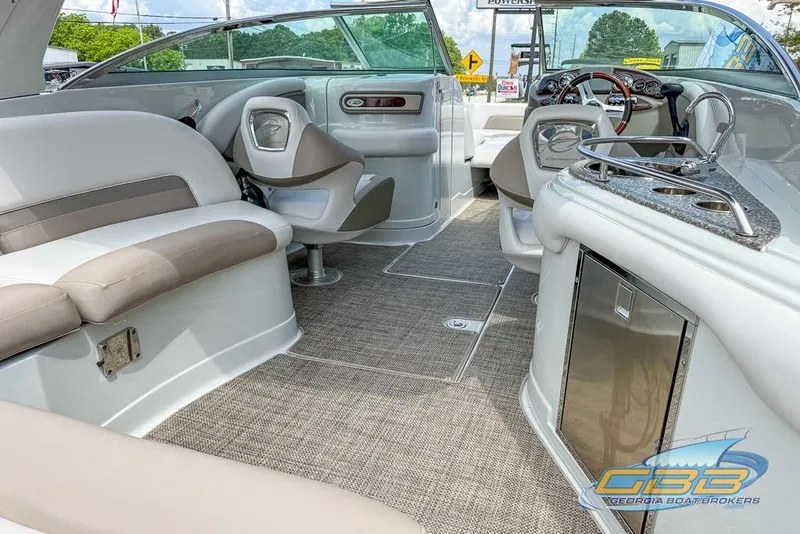 Slide: The Image of 2015 Crownline Eclipse E6 boat interior with seating, helm, and kitchenette. - 2