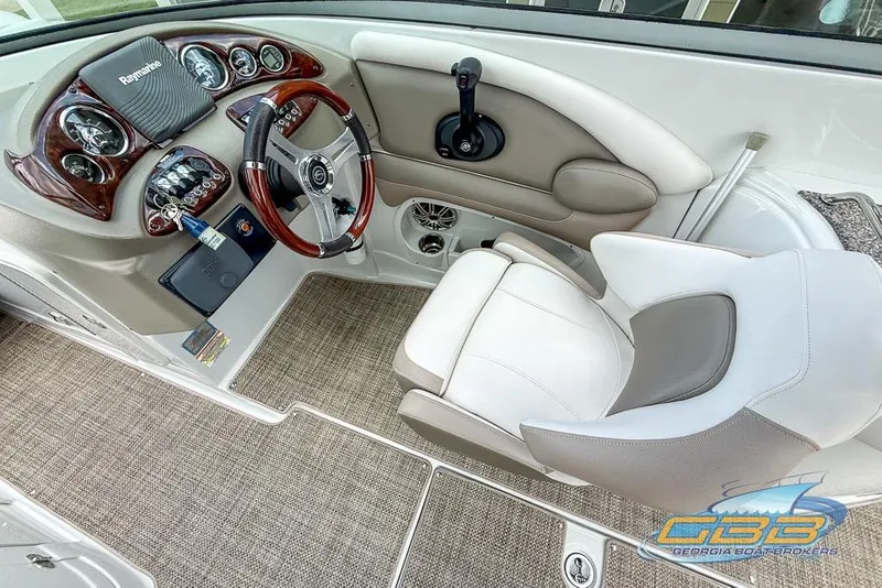 Slide: The Image of 2015 Crownline Eclipse E6 boat cockpit with steering wheel and control panel. - 24