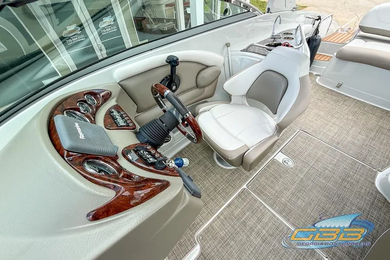 Slide: The Image of 2015 Crownline Eclipse E6 boat cockpit with steering wheel, controls, and comfortable seating. - 25