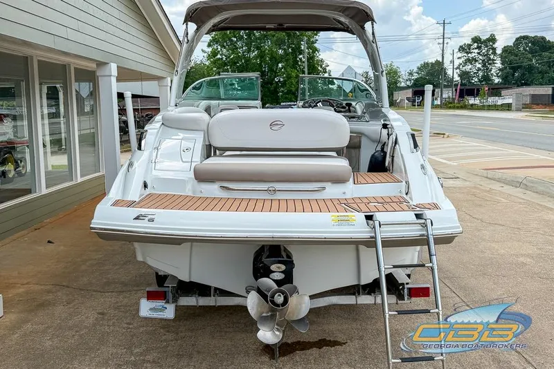 Slide: The Image of 2015 Crownline Eclipse E6 boat with swim platform and ladder, parked outdoors. - 29