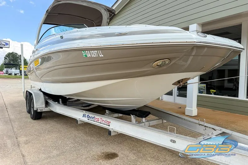 Slide: The Image of 2015 Crownline Eclipse E6 boat on trailer at dealership, showcasing sleek design and modern features. - 30