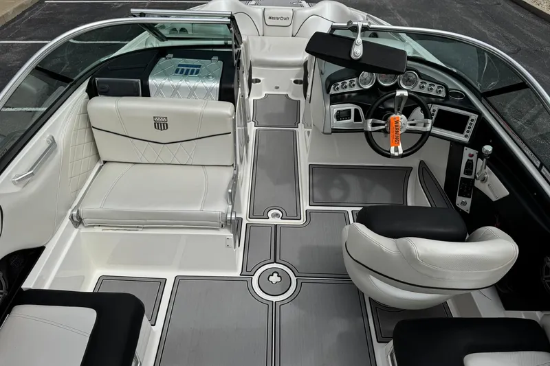 Slide: The Image of 2014 MasterCraft X-35 boat interior with sleek seating and modern dashboard design. - 13