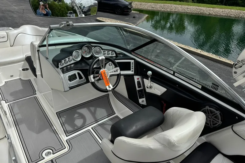 Slide: The Image of Interior of a 2014 MasterCraft X-35 boat, featuring sleek dashboard and steering wheel. - 14