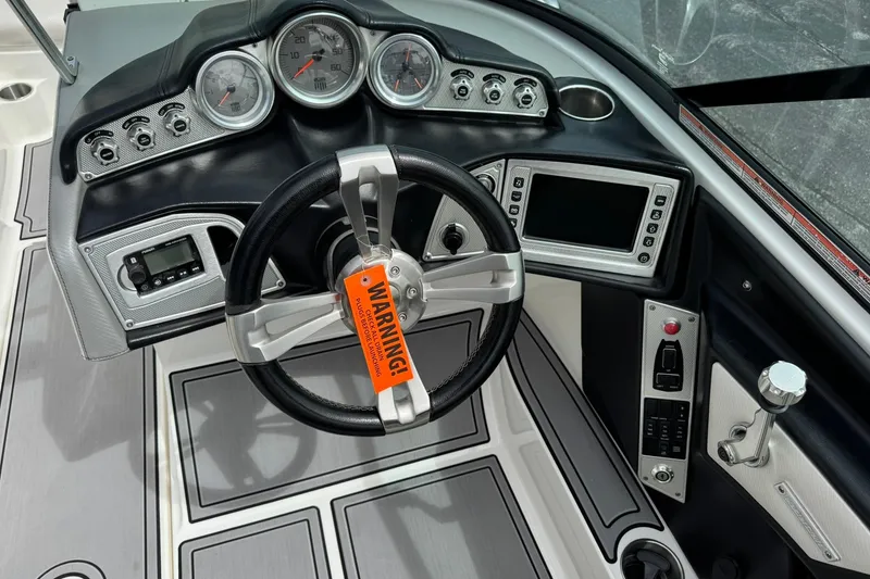 Slide: The Image of Steering wheel and dashboard of 2014 MasterCraft X-35 boat with gauges and controls. - 15