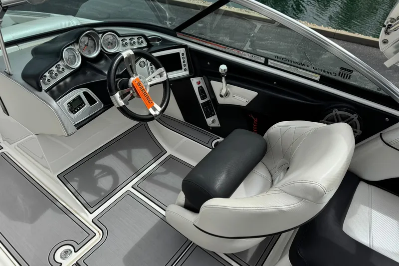 Slide: The Image of Interior of a 2014 MasterCraft X-35 boat, featuring sleek dashboard and comfortable seating. - 16