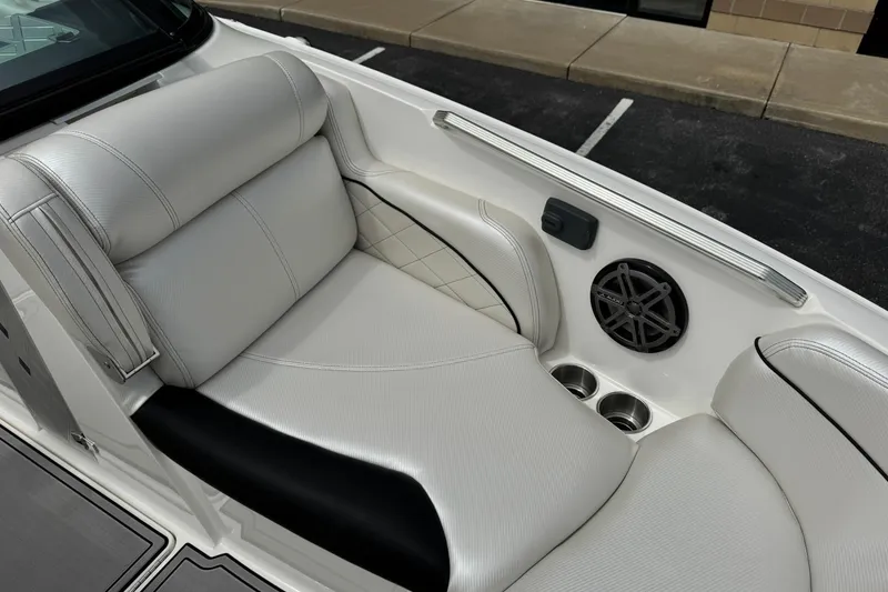 Slide: The Image of Luxurious seating in a 2014 MasterCraft X-35 boat with speaker and cup holders. - 19