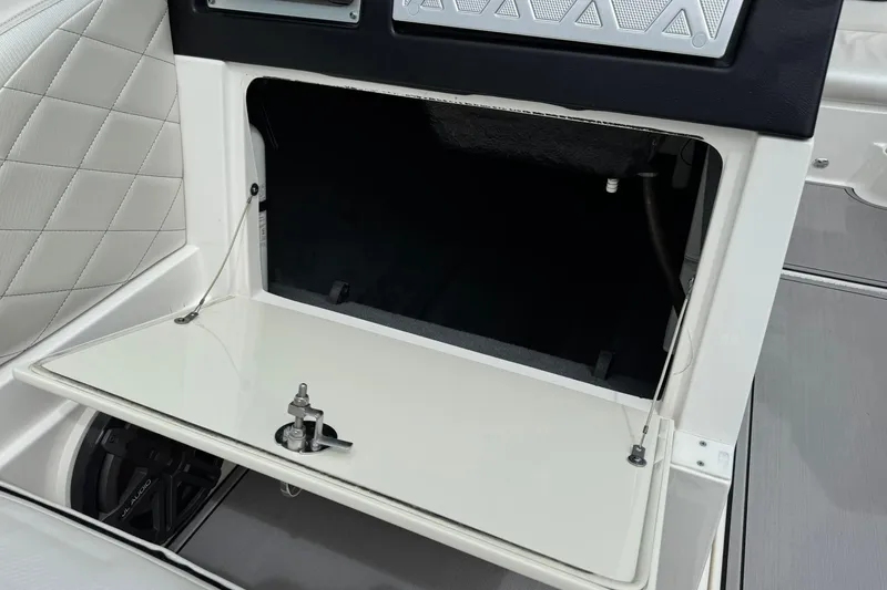 Slide: The Image of 2014 MasterCraft X-35 boat interior storage compartment with open hatch and sleek design. - 25