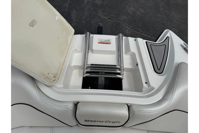 Slide: The Image of 2014 MasterCraft X-35 boat with open storage compartment and ladder. - 28
