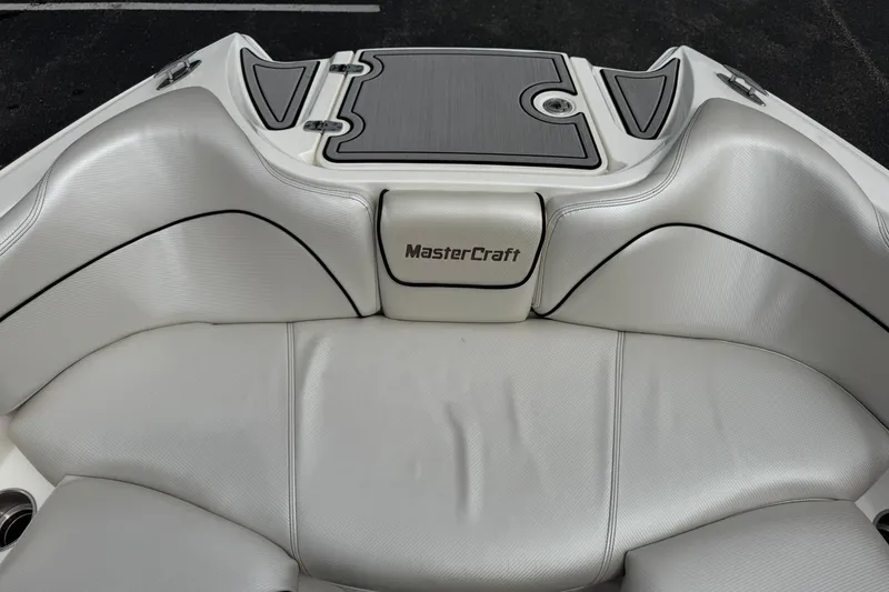 Slide: The Image of 2014 MasterCraft X-35 boat interior with white leather seating and logo. - 29