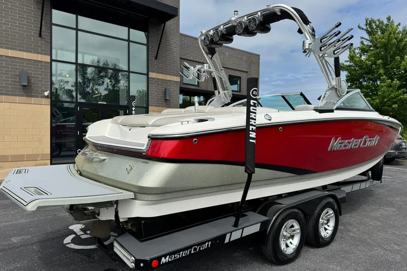 Slide: The Image of 2014 MasterCraft X-35 boat with red and white design on a trailer. - 3