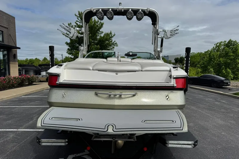 Slide: The Image of 2014 MasterCraft X-35 boat rear view in parking lot, showcasing sleek design and features. - 4
