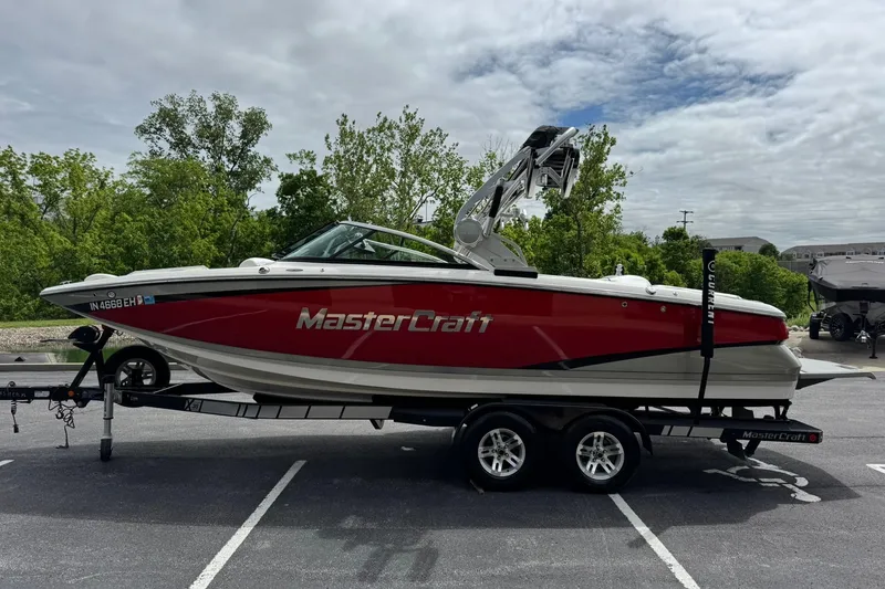 Slide: The Image of 2014 MasterCraft X-35 boat on trailer, red and white, parked outdoors. - 6