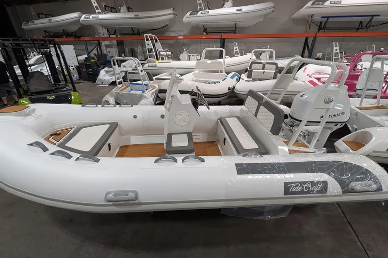 The Image of 2026 Tide Craft Catalina 13 inflatable boat in showroom, featuring Tohatsu engine. - 0