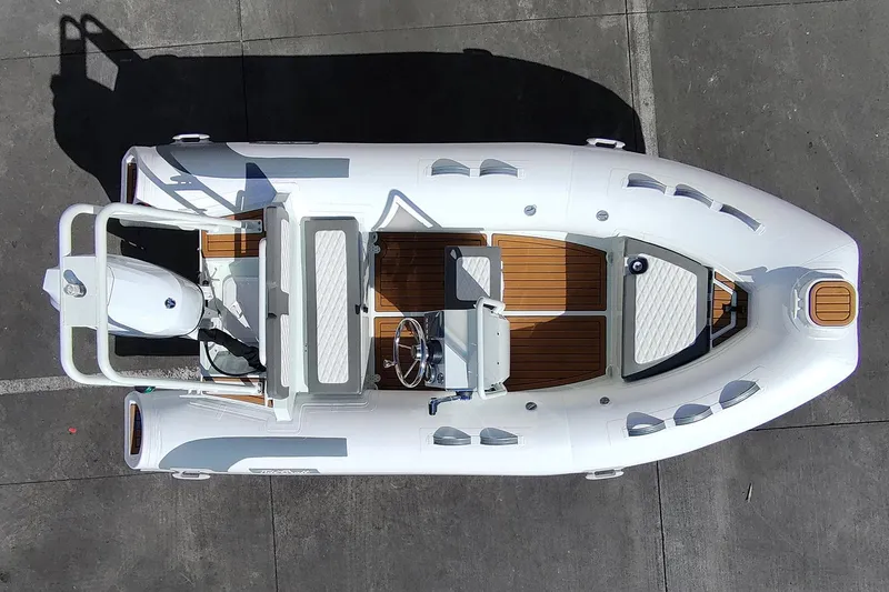 Slide: The Image of Manufacturer Provided Image: 2025 Tide Craft Catalina 13 boat, aerial view, white with wood accents, docked on concrete surface. - 11