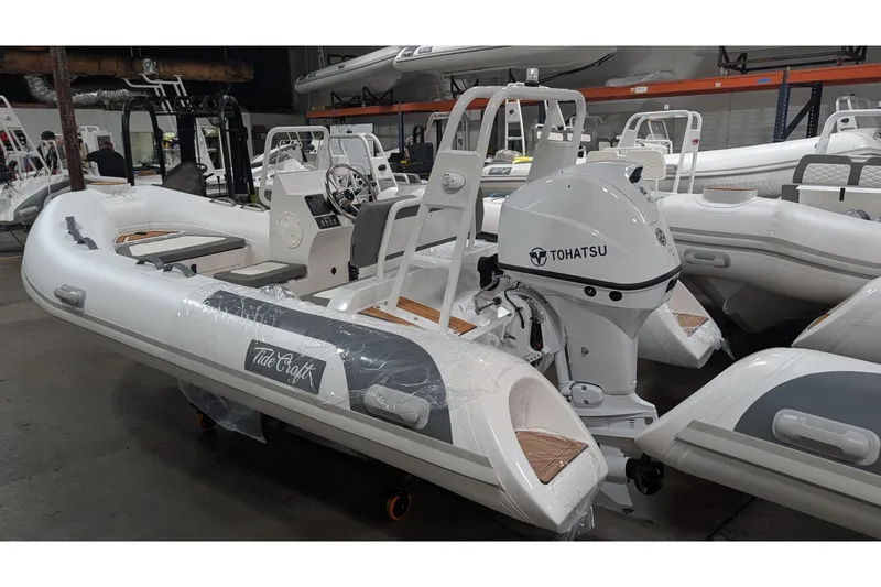 Slide: The Image of 2026 Tide Craft Catalina 13 inflatable boat with Tohatsu outboard motor in showroom. - 2