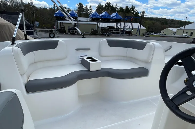 Slide: The Image of 2019 Bayliner Element E16 boat interior with gray seating and cup holders. - 24