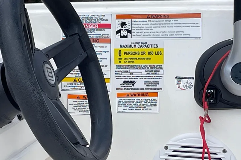 Slide: The Image of 2019 Bayliner Element E16 dashboard with steering wheel and safety warnings. - 25