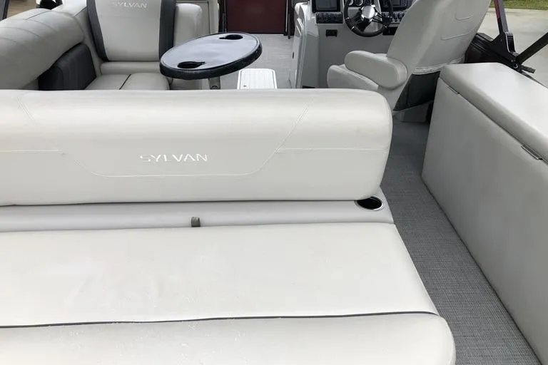 Slide: The Image of Interior of 2022 Sylvan Mirage X X3 CLZ pontoon boat with white seating and steering console. - 4