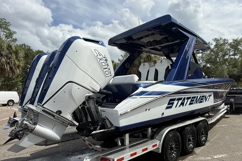 Slide: The Image of 2027 Statement 350 Open boat with triple outboard engines on a trailer. - 1