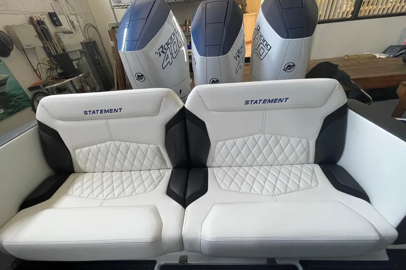 Slide: The Image of Luxury seating on 2027 Statement 350 Open boat with powerful engines in background. - 12