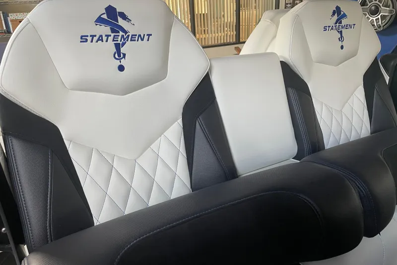 Slide: The Image of Luxury seating in a 2027 Statement 350 Open boat, featuring elegant white and black upholstery. - 13