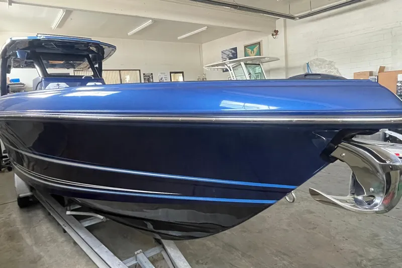 Slide: The Image of Blue 2027 Statement 350 Open boat in a showroom, showcasing sleek design and modern features. - 4