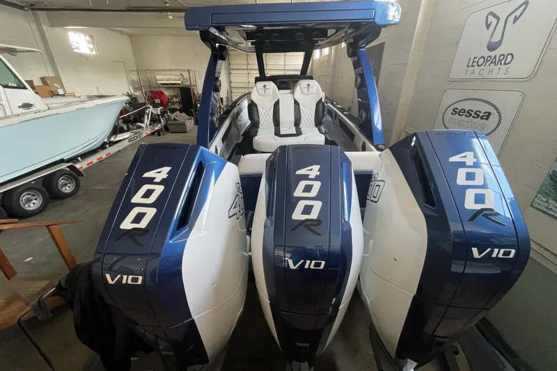 Slide: The Image of 2027 Statement 350 Open boat with triple Mercury 400R V10 engines in a showroom. - 5