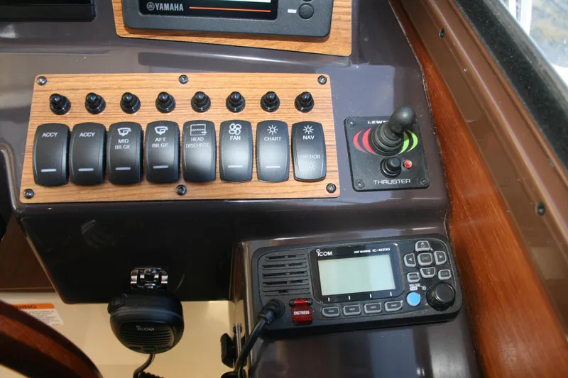 Slide: The Image of Control panel of 2024 Ranger Tugs R-25 boat with switches and marine radio. - 10