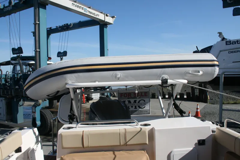 Slide: The Image of 2024 Ranger Tugs R-25 with inflatable boat on deck at marina. - 2