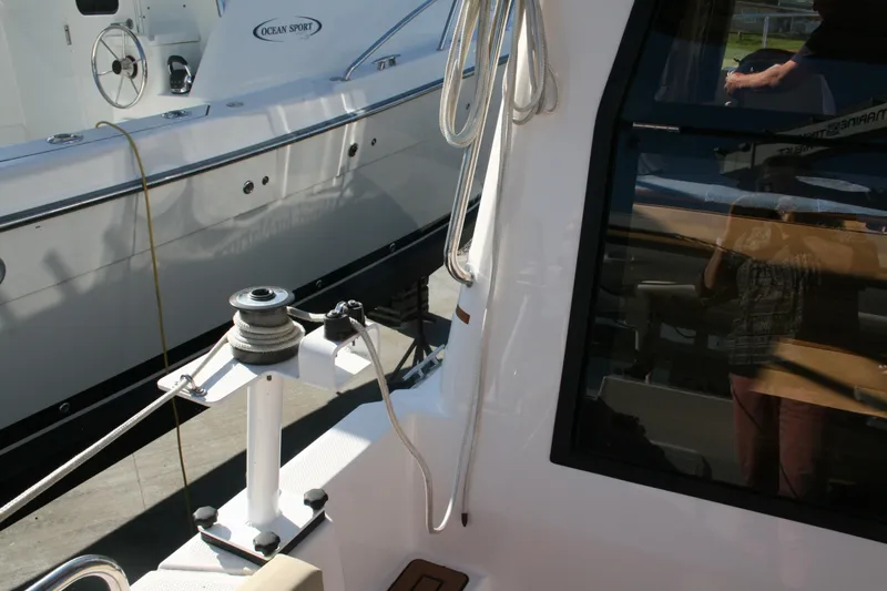 Slide: The Image of 2024 Ranger Tugs R-25 boat deck with winch and rope details. - 3