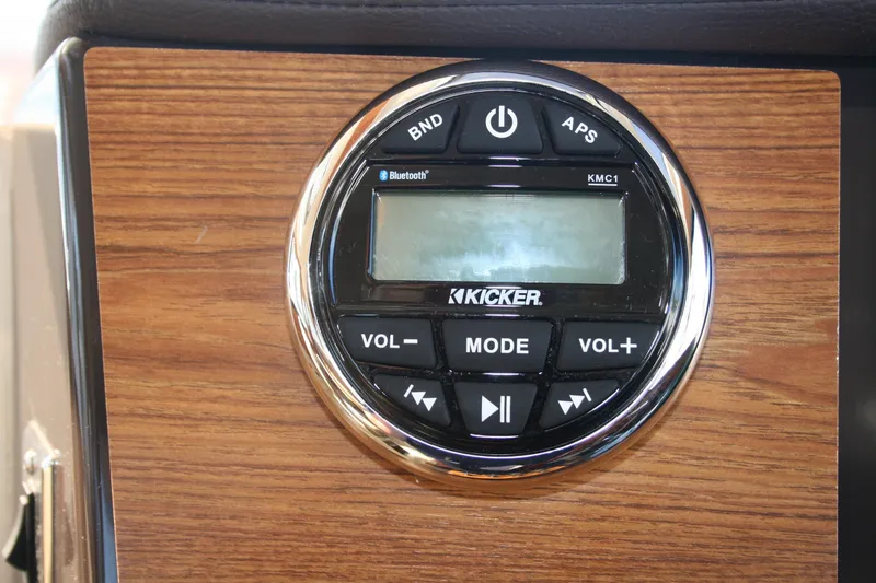 Slide: The Image of 2024 Ranger Tugs R-25 audio control panel with Kicker Bluetooth system on wood finish. - 7
