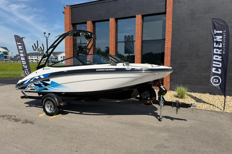 The Image of 2016 Yamaha Boats AR192 on trailer, displayed outdoors near a building. - 1