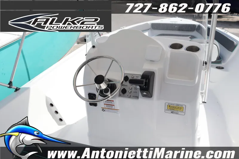 Slide: The Image of Steering console of 2026 ALK2 Powerboats 22 CRS with controls and cup holders. - 6