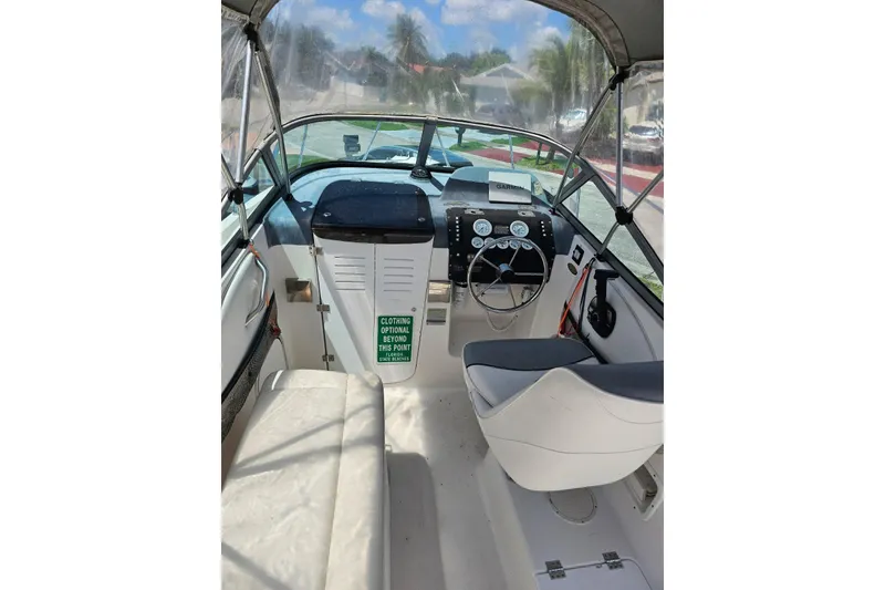 Slide: The Image of 1999 Bayliner 1802 Trophy boat interior with steering wheel and dashboard controls. - 10