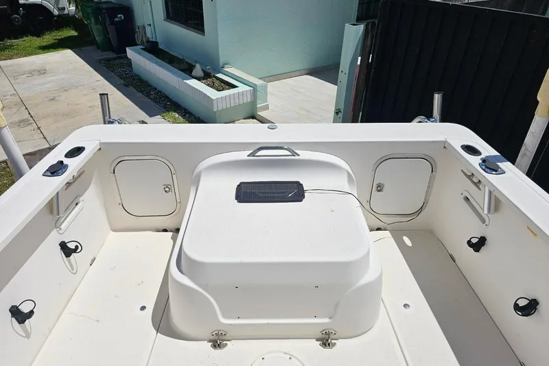 Slide: The Image of 1999 Bayliner 1802 Trophy boat interior with storage compartments and fishing rod holders. - 12