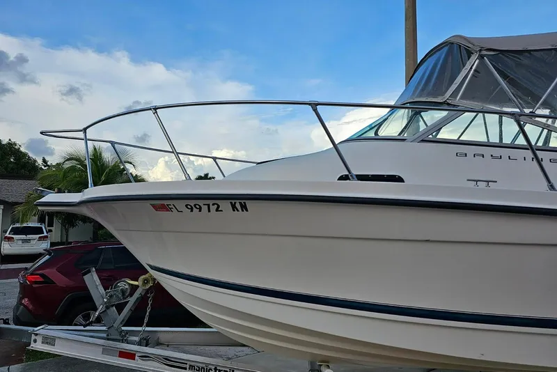 Slide: The Image of 1999 Bayliner 1802 Trophy boat on trailer, parked in residential area. - 2