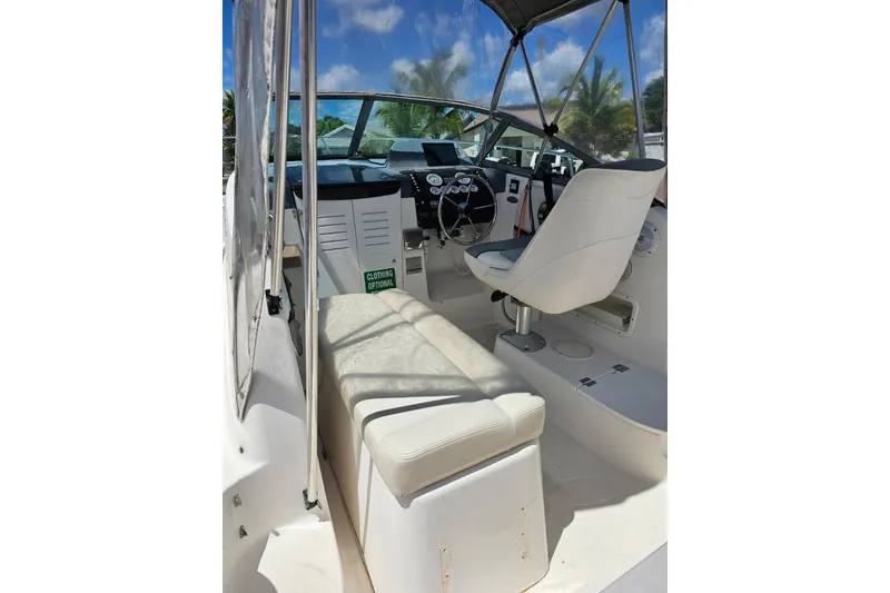 Slide: The Image of 1999 Bayliner 1802 Trophy boat interior with white seating and steering wheel. - 8