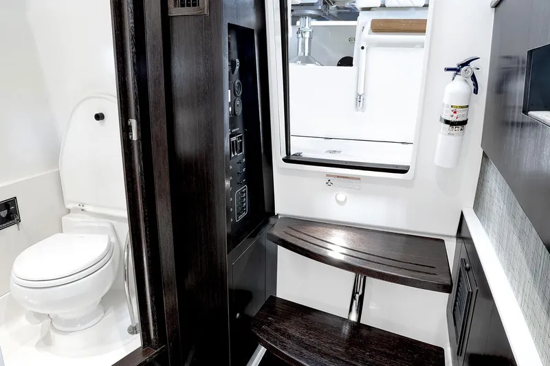 Slide: The Image of Manufacturer Provided Image: Interior of 2021 Pursuit S 378 Sport boat featuring a compact bathroom with toilet and wooden steps. - 14