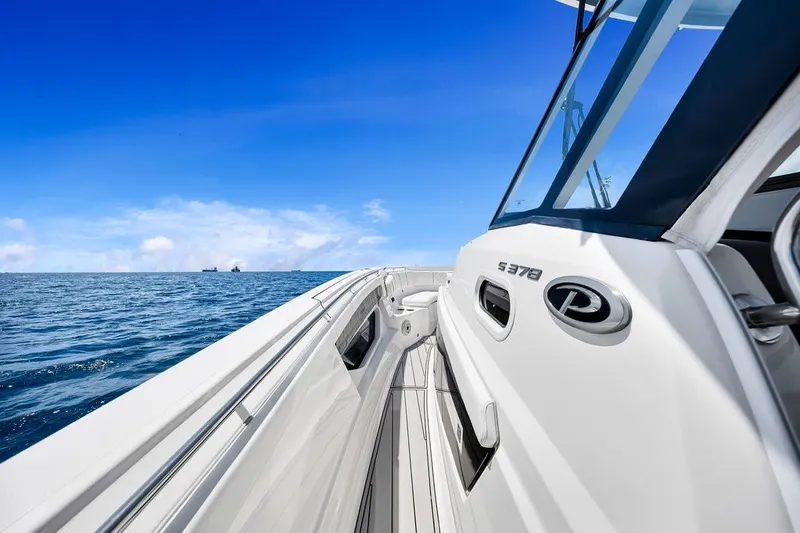 Slide: The Image of 2021 Pursuit S 378 Sport boat cruising on open ocean under clear blue sky. - 17