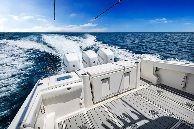 Slide: The Image of 2021 Pursuit S 378 Sport boat cruising on open ocean with powerful engines. - 22