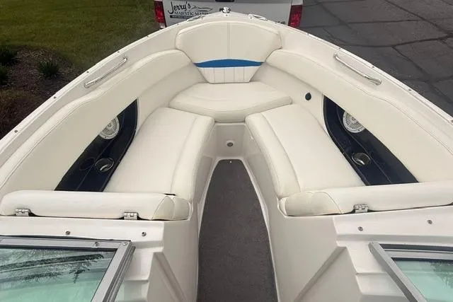 Slide: The Image of 2007 Regal 2200 Bowrider boat with spacious white seating and sleek design. - 10