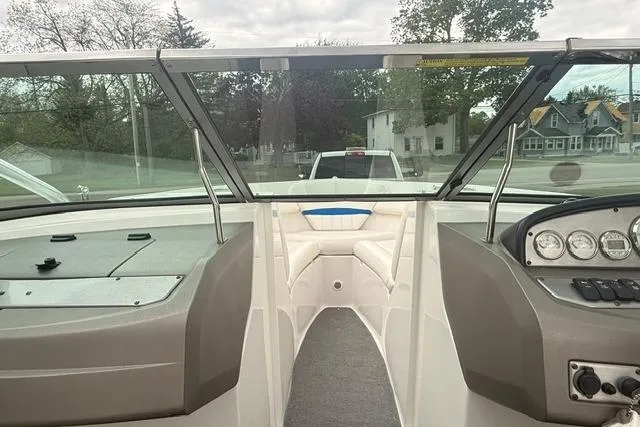 Slide: The Image of 2007 Regal 2200 Bowrider interior with dashboard and seating, parked outdoors. - 11