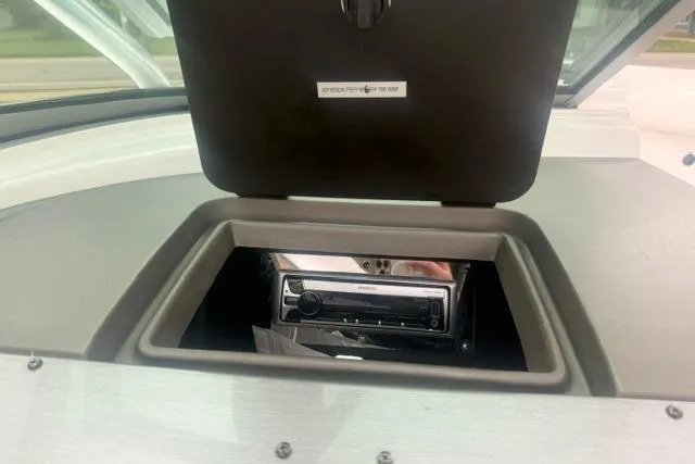 Slide: The Image of 2007 Regal 2200 Bowrider dashboard with open compartment and stereo system. - 12