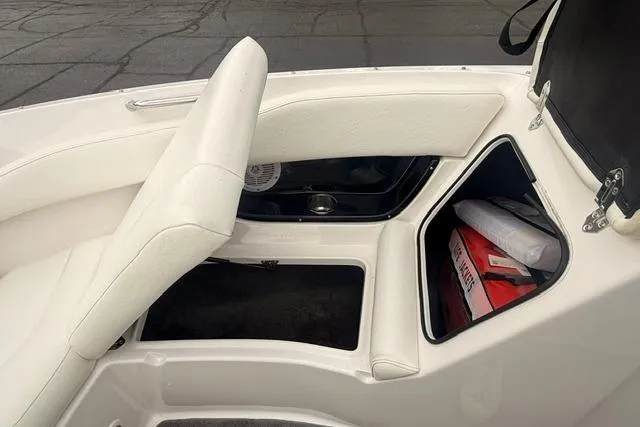 Slide: The Image of 2007 Regal 2200 Bowrider interior storage compartment with safety equipment. - 13