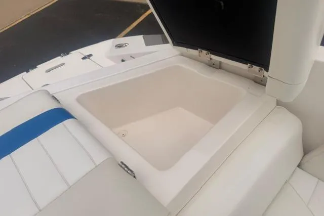 Slide: The Image of 2007 Regal 2200 Bowrider boat storage compartment with open lid, showcasing interior space. - 18