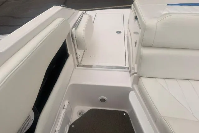 Slide: The Image of 2007 Regal 2200 Bowrider interior with white seating and storage compartments. - 21