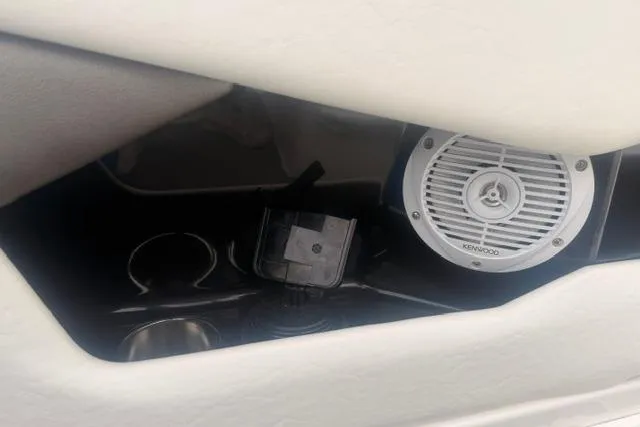 Slide: The Image of Speaker and cup holders in a 2007 Regal 2200 Bowrider boat interior. - 22